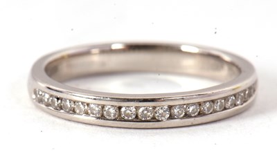 Lot 81 - A platinum half eternity ring, with channel...