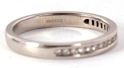 Lot 47 - A platinum half eternity ring, with channel...