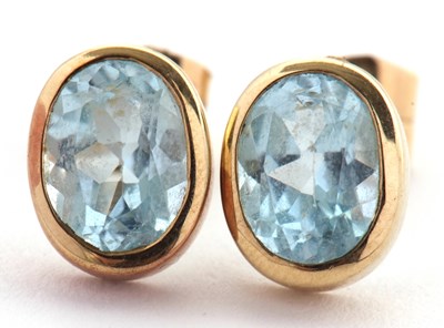 Lot 130 - A pair of blue topaz earrings, the oval mixed...