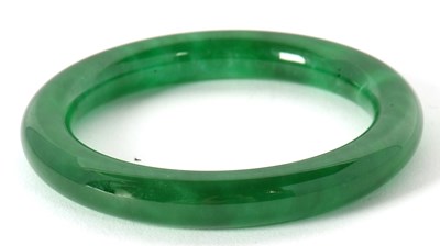 Lot 121 - A jade bangle approx. 1cm thick, inner...
