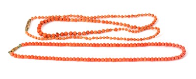 Lot 224 - Two coral bead necklaces, one of uniform beads,...