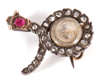 Lot 120 - A diamond and ruby snake brooch, the snake set...