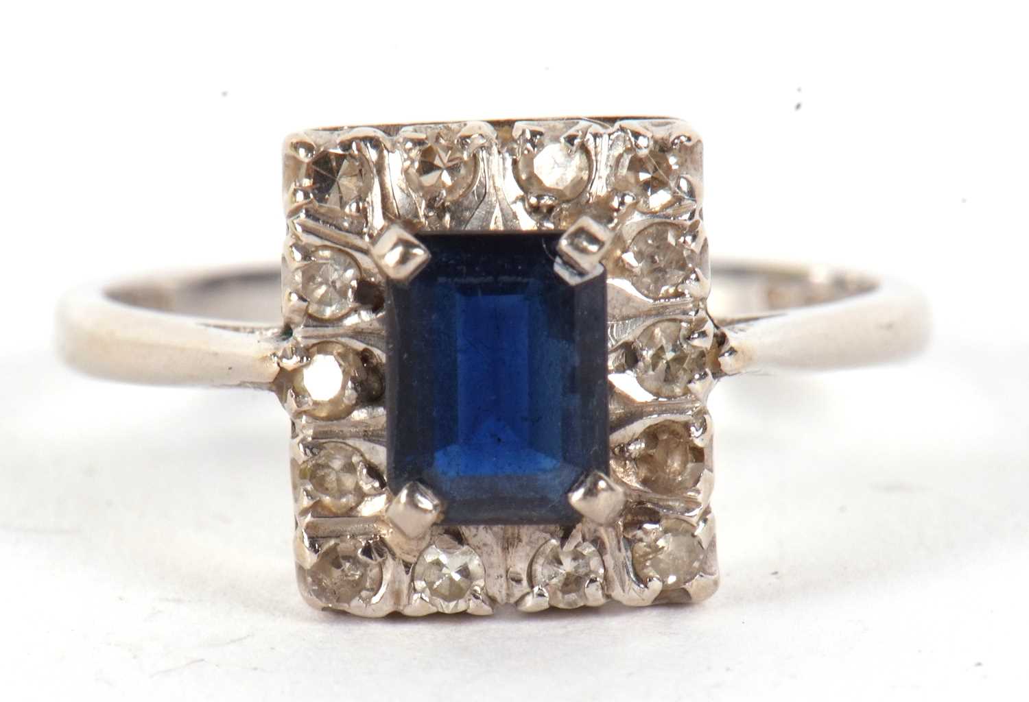 Lot 17 - An 18ct sapphire and diamond ring, the...