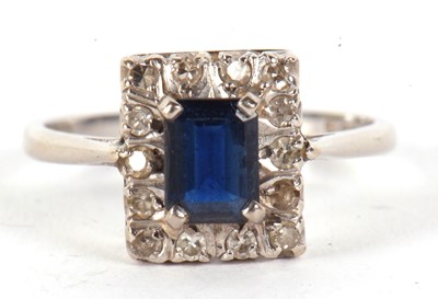 Lot 17 - An 18ct sapphire and diamond ring, the...