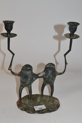 Lot 399 - A metal candle holder shaped as two frogs,...