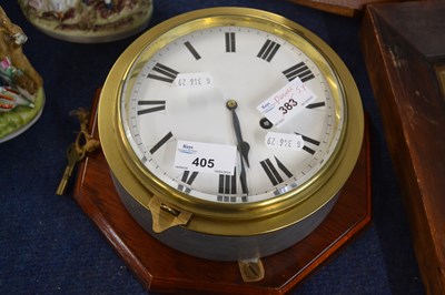 Lot 405 - A ships clock in brass case mounted on shaped...