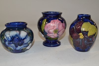 Lot 410 - A group of three small Moorcroft vases, all...