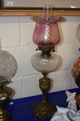 Lot 17 - A brass based oil lamp with clear font and...