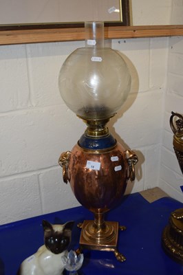 Lot 18 - An oil lamp with bulbous copper body and...