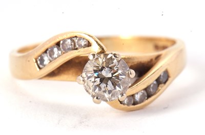 Lot 59 - An 18ct diamond ring, the central round...