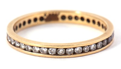 Lot 61 - An 18ct eternity ring, with channel set small...