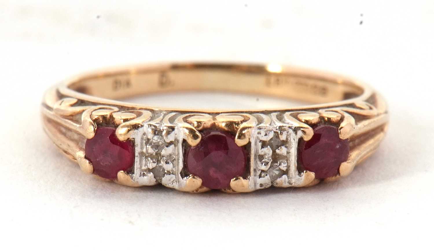 Lot 6 - A 9ct ruby and diamond ring, the three round...