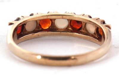 Lot 41 - A 9ct garnet and opal ring, set with...