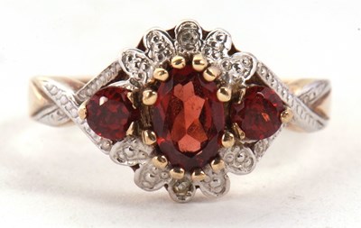 Lot 62 - A 9ct garnet and diamond ring, set with a...