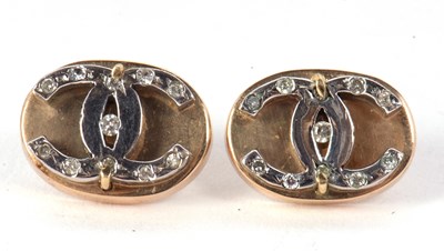 Lot 109 - A pair of diamond earrings, the oval discs set...