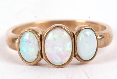 Lot 63 - A 9ct opal ring, the three oval opal cabochons...