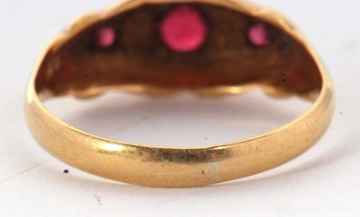 Lot 52 - An 18ct red stone and diamond ring, the three...