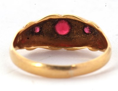Lot 52 - An 18ct red stone and diamond ring, the three...