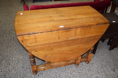 Lot 315 - 20th Century oval oak drop leaf dining table...