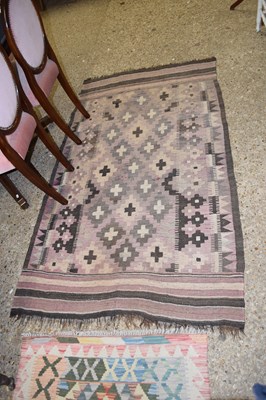 Lot 344 - A small Killim rug in muted colours with...