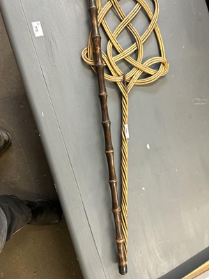 Lot 743 - A carpet beater and a walking stick