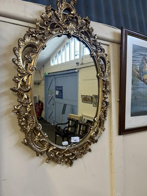 Lot 757 - An oval gilt framed wall mirror