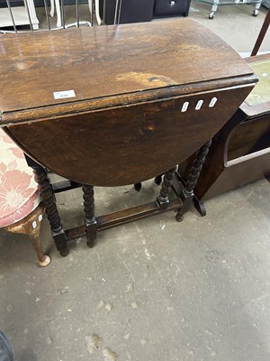 Lot 830 - An oval drop leaf table with barley twist legs