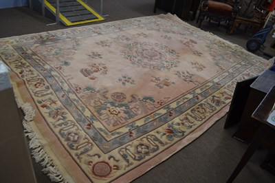 Lot 581 - A large Chinese pink washed wool carpet...