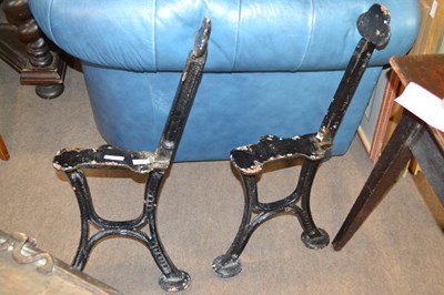 Lot 525 - A pair of cast iron bench ends, the legs...