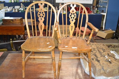 Lot 542 - A miniature wheel back elm seated carver chair...