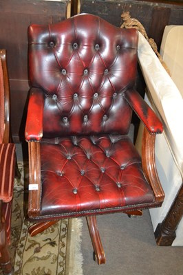 Lot 600 - A red leather upholstered revolving office chair