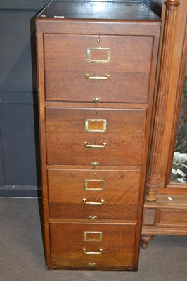 Lot 566 - An early 20th Century oak four drawer filing...