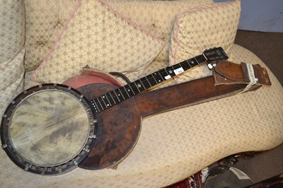 Lot 625 - An antique banjo with six strings, stamped to...