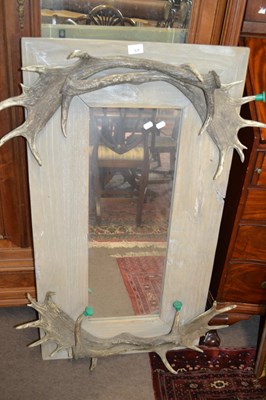 Lot 626 - A contemporary wall mirror with antler mounts,...