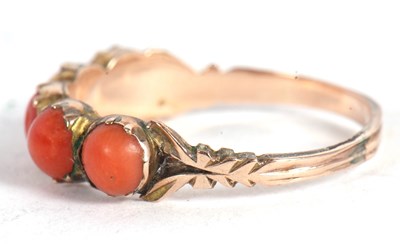 Lot 17 - A coral ring, the five round coral cabochons...
