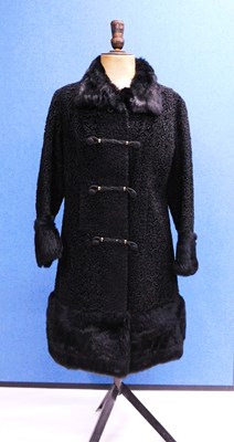 Lot 83 - A black astrakhan coat by Astra Furs, Paris,...