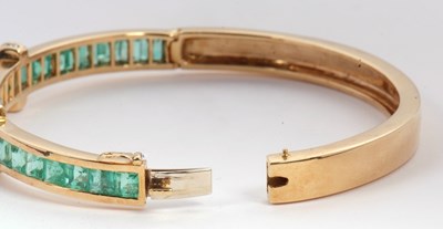 Lot 361 - An emerald and diamond bangle, the upper half...