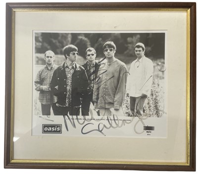 Lot 156 - A framed and glazed presentation for Oasis,...