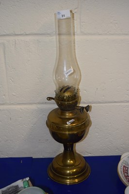 Lot 31 - A brass based oil lamp