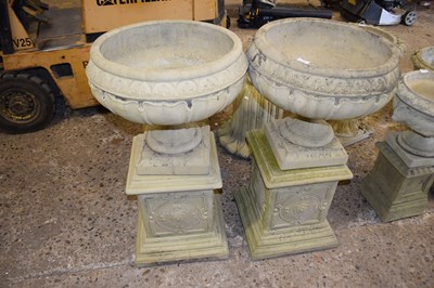 Lot 1089 - A pair of composite garden planters on plinths