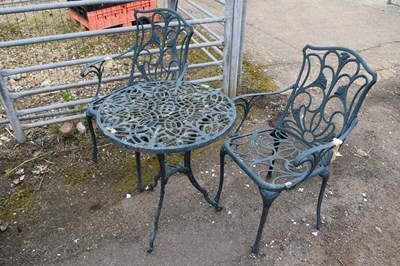 Lot 1114 - Cast bistro set comprising two chairs and a table