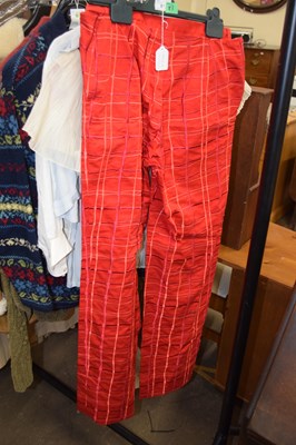 Lot 67 - A pair of trousers by Bottega Veneta, the red...