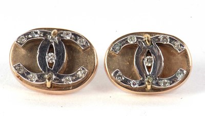 Lot 81 - A pair of diamond earrings, the oval discs set...