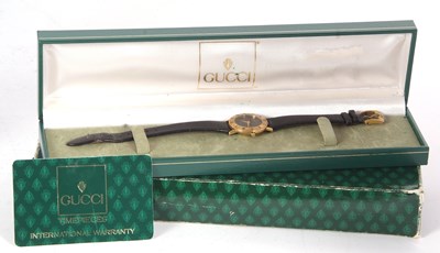 Lot 256 - A ladies Gucci 3000L wristwatch, the outer box,...