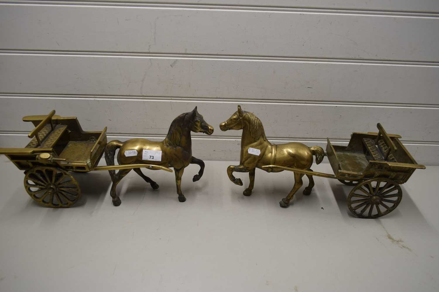 Lot 73 - TWO BRASS HORSES AND CARTS