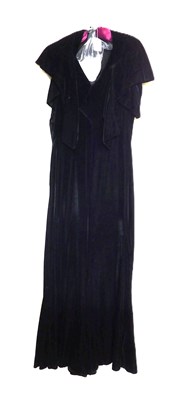 Lot 19 - A black velvet evening gown, the sleeveless...