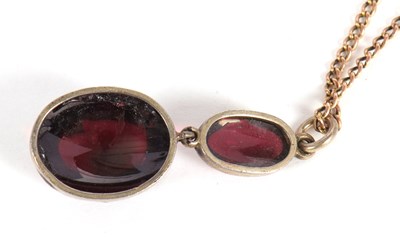 Lot 60 - A garnet pendant, the two oval garnets in...