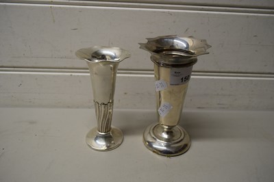 Lot 150 - TWO SMALL SILVER STEM VASES ON LOADED BASES,...