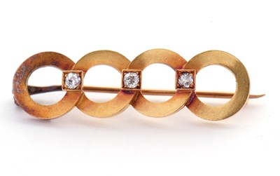 Lot 72 - A diamond brooch, the four rings set with...
