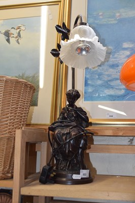 Lot 553 - A bronzed figural lamp with frosted glass shade